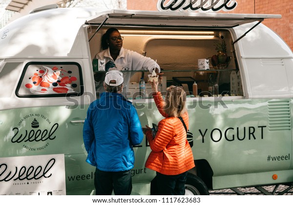 Lisbon, June 18,
2018: People buy frozen yogurt or ice cream from a street vendor.
Street food and mobile
commerce