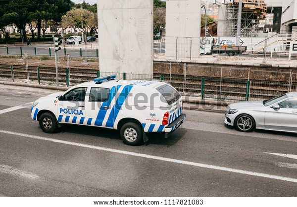 Lisbon, June 18, 2018: A\
police car is driving down the city street. Protection of public\
order