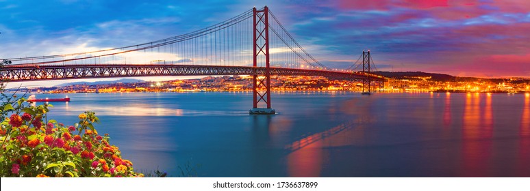 Lisbon landscape at sunset.Panoramic photograph of the 25 de Abril bridge in the city of Lisbon over the Tajo River.