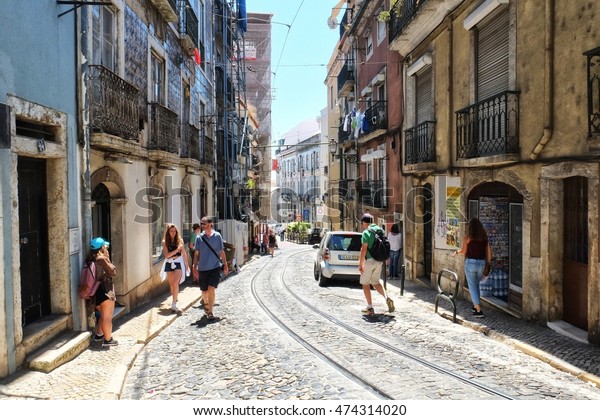 Lisbon, Portugal - 08.02.2016: People\
exploring the narrow streets of Alfama in\
Lisbon