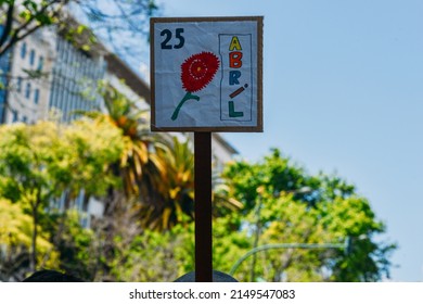 Lisbon, Portugal - April 25, 2022: Crowds Of Portuguese Hold Carnation Flowers At Avenida Da Liberdade In Lisbon To Celebrate The Military Coup That Overthrew The Authoritarian Regime In 1974