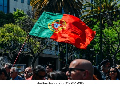 Lisbon, Portugal - April 25, 2022: Crowds Of Portuguese Hold Carnation Flowers At Avenida Da Liberdade In Lisbon To Celebrate The Military Coup That Overthrew The Authoritarian Regime In 1974