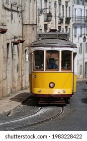 Lisbon , Portugal ; April 7 2021 : The Yelow Tram 28 With The Driver Wearing A Mask For Covid 19