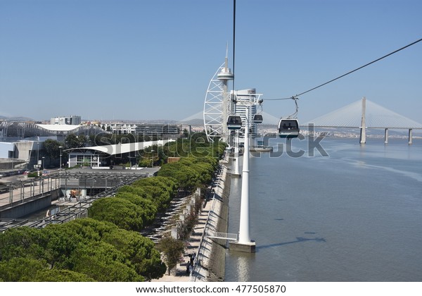 LISBON, PORTUGAL - AUG 21: Telecabine Lisboa at\
Parque das Nacoes (Park of Nations) in Lisbon, Portugal, as seen on\
Aug 21, 2016. The cable cars overlook the Vasco da Gama bridge on\
the Tagus river.