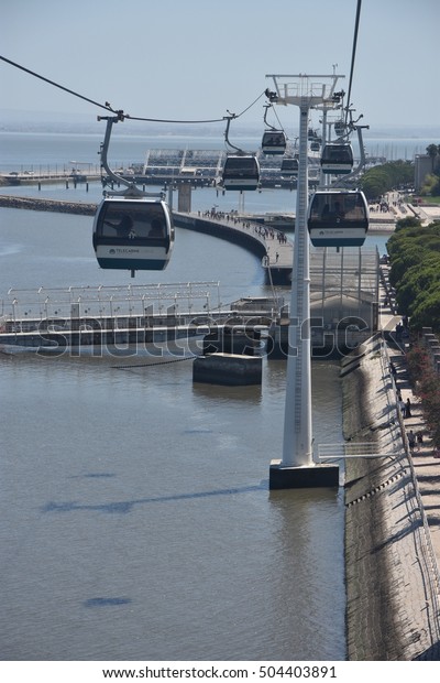 LISBON, PORTUGAL - AUG 21: Telecabine Lisboa at\
Parque das Nacoes (Park of Nations) in Lisbon, Portugal, as seen on\
Aug 21, 2016. The cable cars overlook the Vasco da Gama bridge on\
the Tagus river.