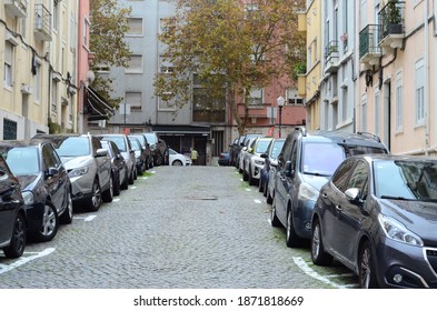 Lisbon, Portugal - December 10th 2020 - Street In Lisbon, Penha De França, With Old Buildings, Cars Parked And Trees.