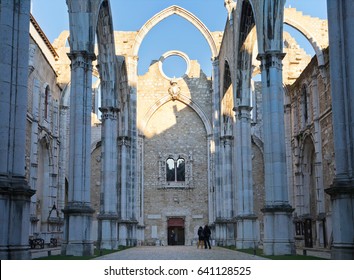 LISBON, PORTUGAL - December 20, 2011: Tourists visiting the interior view of the Gothic church of Carmo, destroyed by the earthquake of 1755 (Church of Our Lady of Mount Carmel),  Lisbon, Portugal