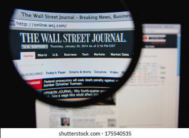 LISBON, PORTUGAL - FEBRUARY 8, 2014: Photo Of The Wall Street Journal Homepage On A Monitor Screen Through A Magnifying Glass.