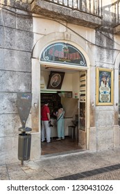 LISBON, PORTUGAL - JULY 20, 2015: Customers At A Ginjinha, The Famous Liqour Shop In Lisbon, Buying The Traditional Portuguese Liqueur Made With Sour Cherries