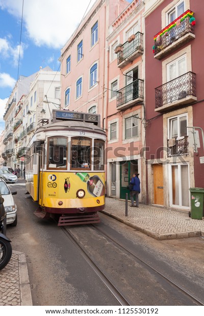 Lisbon, Portugal -\
June 4, 2018: Iconic yellow tram 28 to Largo de Camões in Lisbon\
street. In São Bento\
street.