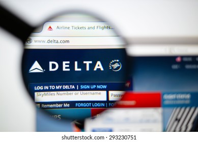 LISBON, PORTUGAL - June 6, 2015. Photo of Delta Air Lines homepage on a monitor screen through a magnifying glass.