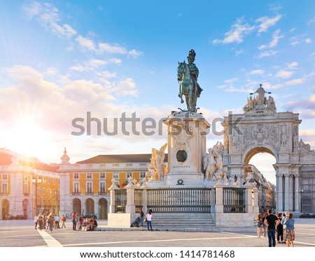 Lisbon, Portugal. King Jose I Statue at Praca do Comercio in front of Triumphal Arch near waterfront. Old town of Lisboa in historic midtown Alfama district. Evening sunset and blue sky with clouds.