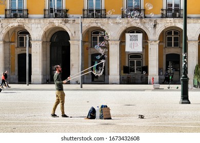 Lisbon, Portugal- March 9, 2020: Bubble Man Street Performer At The Mains Square In Lisbon Called Praca Do Comercio , Commerce Square