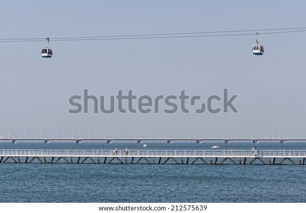 Lisbon,\
Portugal - May 15: The Cable Car and Vasco da Gama Bridge in Lisbon\
on May 15, 2014. The Cable Car provides an air trip over the whole\
of the Park of Nations. Portugal,\
Europe.