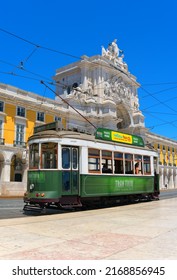 Lisbon, Portugal - May, 25 2019: The historic tram route of Lisbon. A tourist tram stands at the terminus of the historic tram route on Commerce Square with the Rua Augusta Arch in the background.