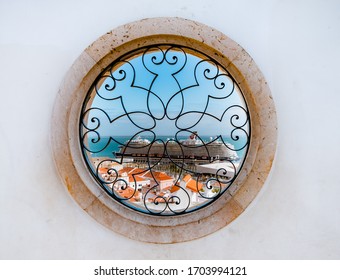 Lisbon, Portugal - November 3, 2019 : View Of A Merchant Ship From A Round Window. Alfama District, Lisbon, Portugal