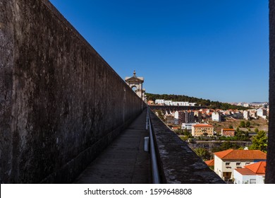 LISBON, PORTUGAL - OCTOBER 10, 2019: View Of Águas Livres Aqueduct On Left Side And Lisbon Cityscape On Right Side.