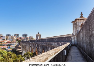 LISBON, PORTUGAL - OCTOBER 10, 2019: View Of Turning Poin Of Águas Livres Aqueduct With Cityscape On A Background.