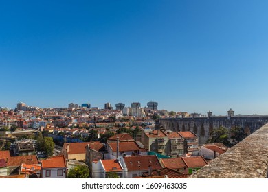 LISBON, PORTUGAL - OCTOBER 10, 2019: Águas Livres Aqueduct With Cityscape On A Background On A Sunny Day, Horizontal Crop.