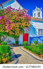 Lisbon, Portugal - October 23, 2018 - Traditional Portuguese Small Catholic Church Backyard with Azulejo Wall Paintings and Blooking Garden in Lisbon , October 23, 2018