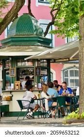 Lisbon, Portugal; September-01, 2021: Kiosk bar with people at tables having snacks under the trees in a square in Lisbon (Portugal) 