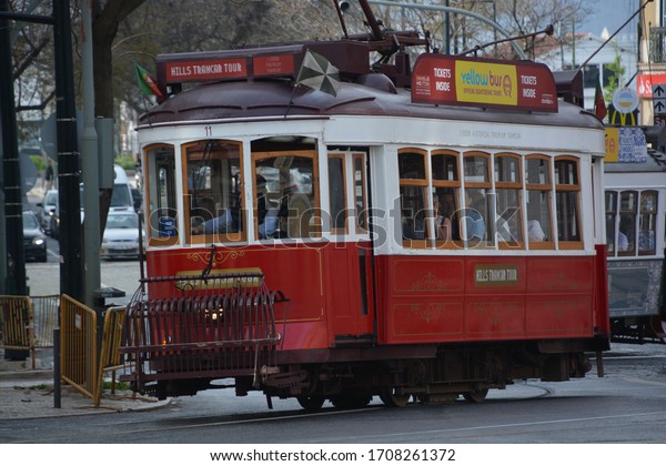 Lisbon,\
Portugal-April 2019: Close up of a tram in Lisbon taking tourists\
through the narrow streets of the\
city