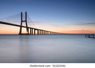 Lisbon and Vasco da Gama Bridge are an amazing tourist destination because their urban landscapes and its monuments. The Bridge crosses the Tagus River, and is one of the longest bridges in the world. - Shutterstock ID 511221541