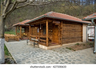 Lisine, Serbia - April 03, 2016: Porch on the houses made of logs of wood with garden furniture of bamboo