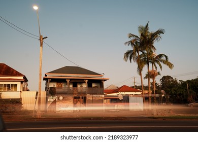 Lismore, New South Wales, Australia; 22.03.2022: Damaged Private House By The Roadside At Dusk, Piles Of Rubbish Outside After The New South Wales Floods In February 2022