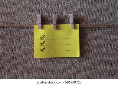 List to do  written on a wooden table and paper sticky notes.