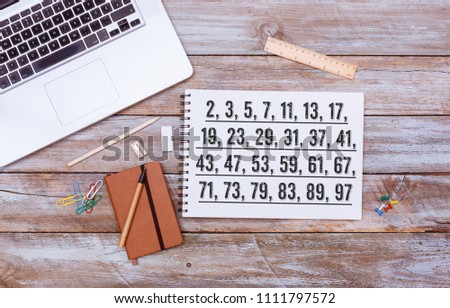 List of Prime Numbers below 100, text written on paper note pad, grunge wood table flat lay shot from above Stockfoto © 