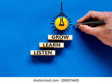 Listen, Learn, Grow Symbol. Wooden Blocks With Concept Words Listen, Learn, Grow. Blue Background. Businessman Hand, Light Bulb Icon. Copy Space. Business, Educational And Listen, Learn, Grow Concept.