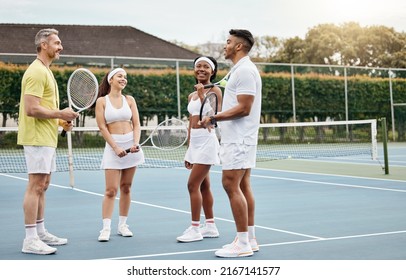 Listen to your coach. Full length shot of a handsome mature male tennis coach talking to his students out on the court. - Powered by Shutterstock