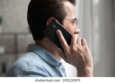 I Am Listening. Cropped Side Shot Of Skilled Male Professional Expert Consulting Customer By Phone Hold Device To Ear. Confident Young Man Client Support Manager Answering Call Speak Talk Help Caller