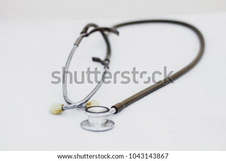 The stethoscope is an acoustic medicaldevice for auscultation, or listening to the internal sounds of an animal or human body on white background , soft focus , blurred , out of focus.