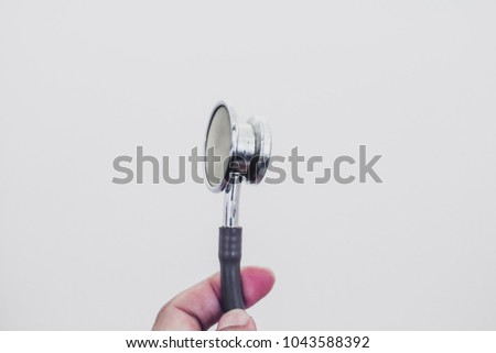 The stethoscope is an acoustic medicaldevice for auscultation, or listening to the internal sounds of an animal or human body on white background , soft focus , blurred.