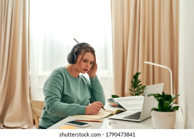 Listening Online Course. Young Focused Woman, Female Student Wearing Headphones, Studying Foreign Language Online While Sitting At Desk With Laptop. Online Study. Distance Education.