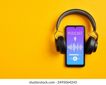 Listening podcast with smartphone player app. Smartphone and wireless headphone with podcast screen on yellow background.