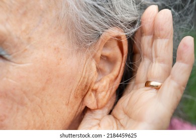 Listening To Problems Hand Behind The Ear To Hear Better. Hearing Problems In Older People, Close Up Of Ear, Ear And Hand Of Deaf Woman. Gesture To Listen Better In People With Deafness, Old Ear Woman