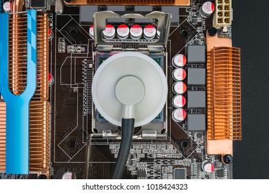 Listening to the processor with a stethoscope on an old motherboard to fix a broken computer on a black desk. Flat lay.