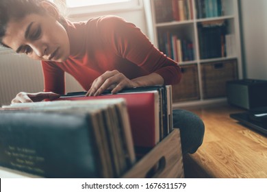 Listening Vinyl Records. Hipster Girl Searching For Favorite Vinyl Record At Her Home 