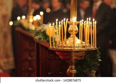 Lit Beeswax Candles In Candle Stand