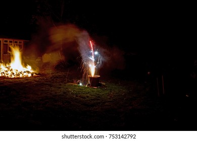 lit Firework on the ground with Bonfire in the background - Shutterstock ID 753142792