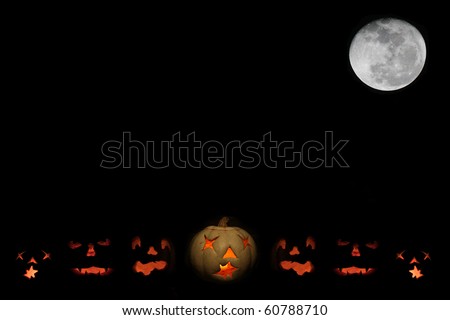 Lit jack o-lanterns under a full moon against a black night sky with room for your text