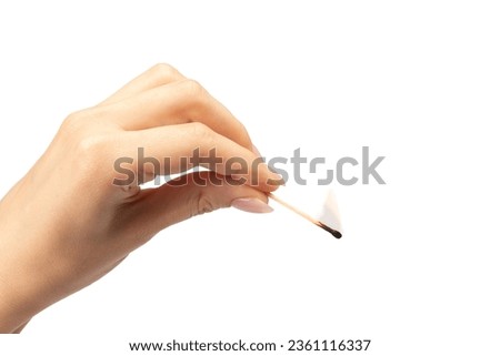 Lit match in a woman hand isolated on a white background. Copy space. 