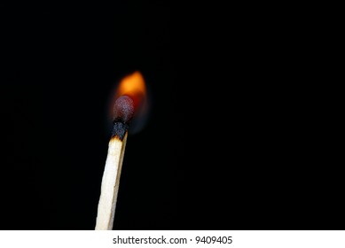 Lit matchstick with dark background