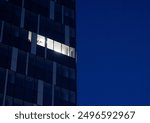 A lit up office space in an otherwise empty office bulding