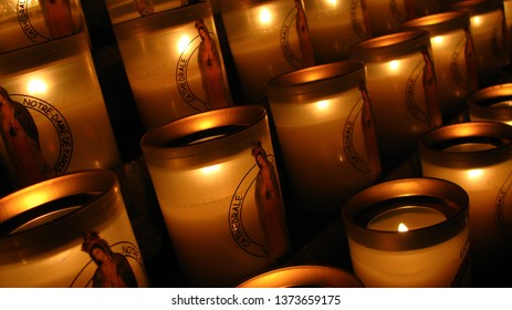 Lit Up Rows Of Candles With Image Of Saint Maria At The Cathedral Notre Dame De Paris, France Before The Fire Hazard Arranged And Displayed At The Church.