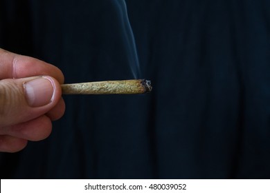 Lit Smoking Cannabis Or Marijuana Cigarette Joint