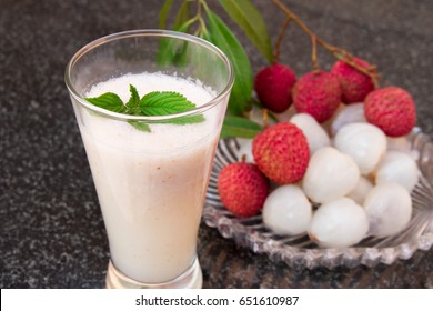Litchi juice in a glass. Fresh juicy lychee fruit on a glass plate. Organic leechee sweet fruit. Organic fruit concept. Exotic tropical litschi berry. Peeled lychee fruit.